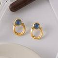 Blue resin stainless steel earrings with a touch of understated luxury.
