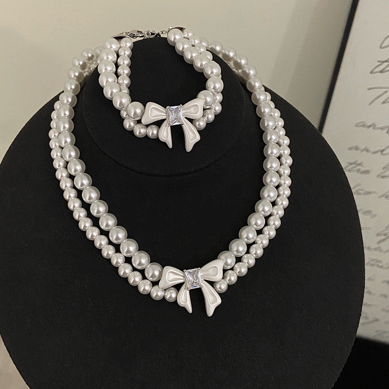 Double-layer pearl bow zircon copper alloy set