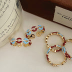 Vintage-style glazed zircon ring in copper alloy