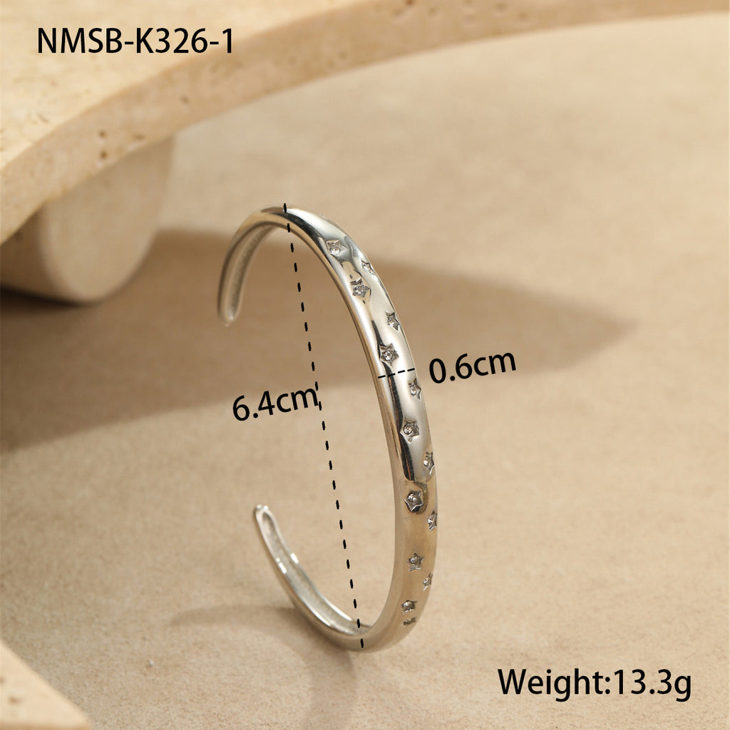 Stylish stainless steel bracelet with a striking five-pointed star design and diamond embellishments.
