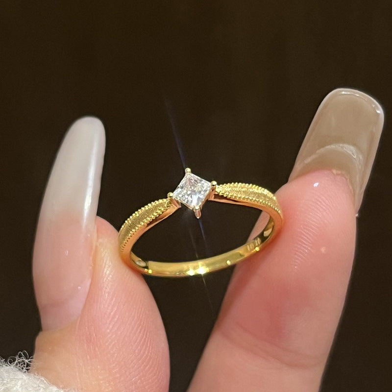 Vintage plain band brass alloy ring with single or square diamonds.