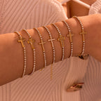 Cross-shaped diamond-encrusted stainless steel bracelet that won't fade.