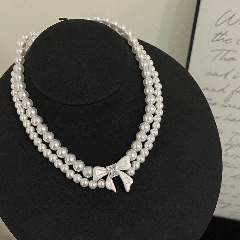 Double-layer pearl bow zircon copper alloy set