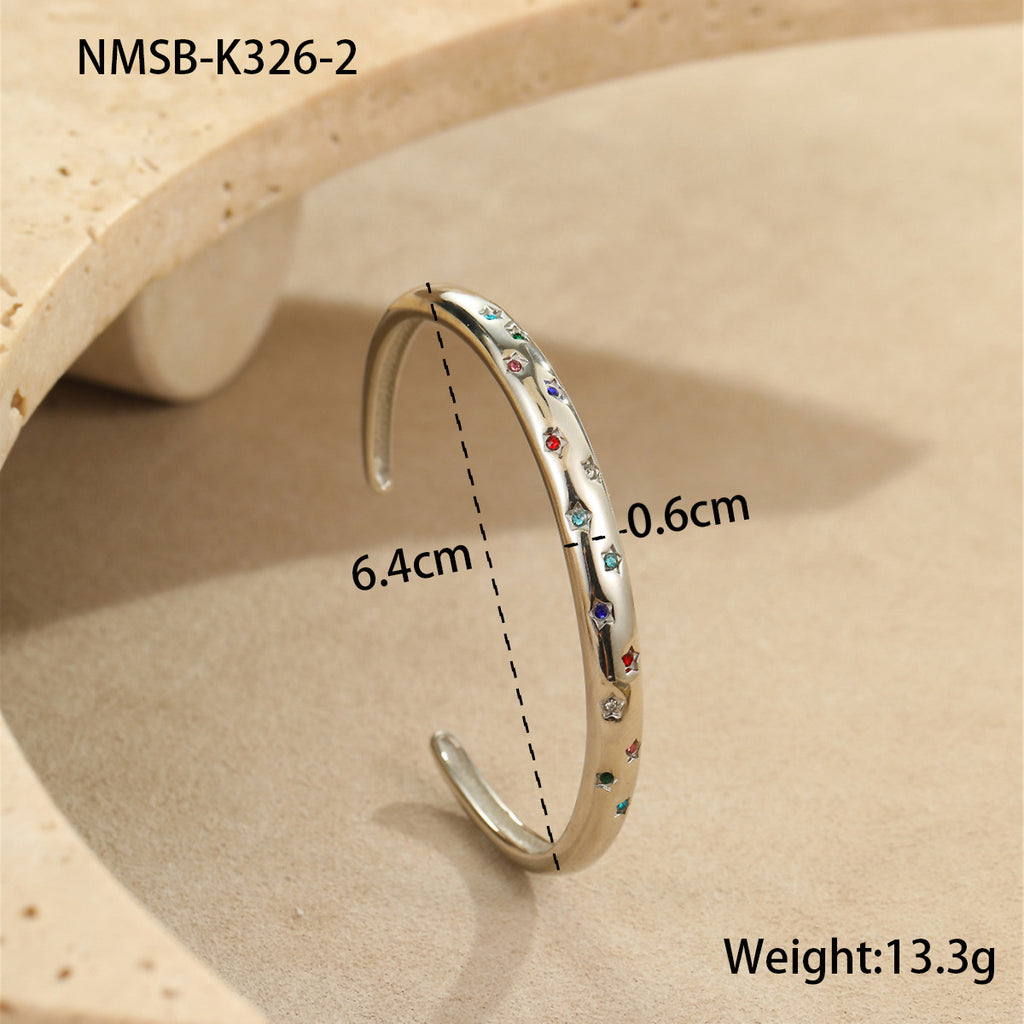 Stylish stainless steel bracelet with a striking five-pointed star design and diamond embellishments.
