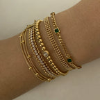 Stainless steel stacked bracelet with PVD-plated small gold beads and gold chain