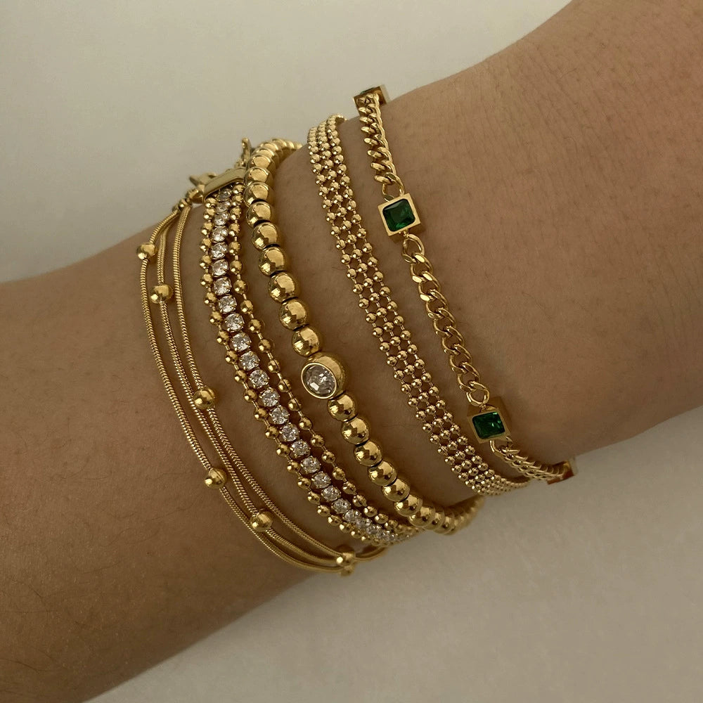 Stainless steel stacked bracelet with PVD-plated small gold beads and gold chain