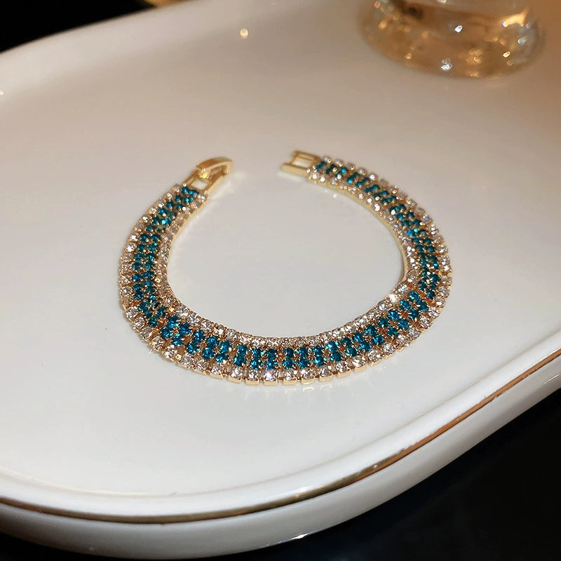 Retro-style, subtly luxurious stainless steel bracelet with diamond-encrusted geometric clasp.