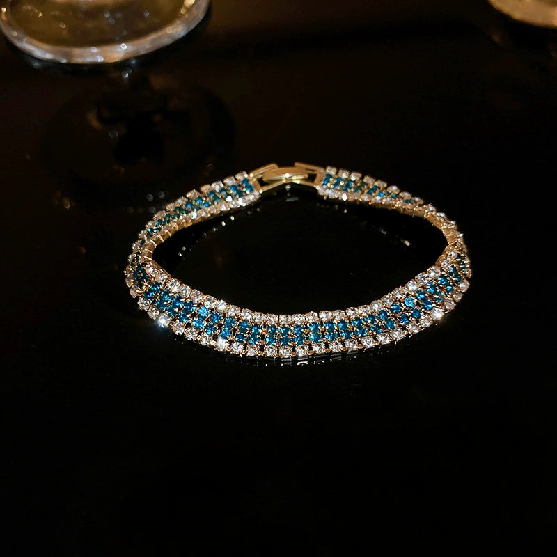 Retro-style, subtly luxurious stainless steel bracelet with diamond-encrusted geometric clasp.