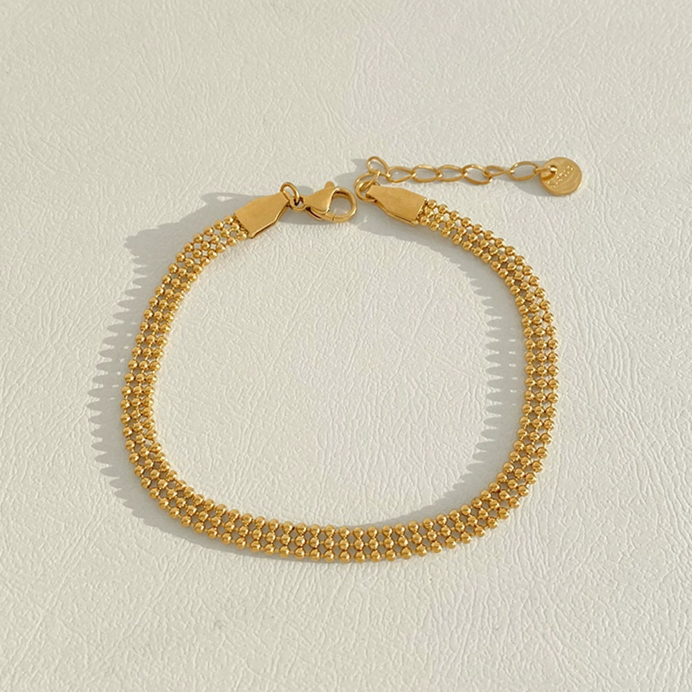 Stainless steel stacked bracelet with PVD-plated small gold beads and gold chain