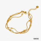Stainless steel stacked bracelet with PVD-plated small gold beads and gold chain