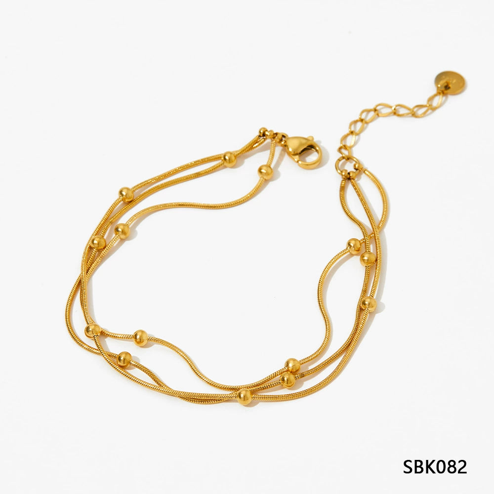 Stainless steel stacked bracelet with PVD-plated small gold beads and gold chain