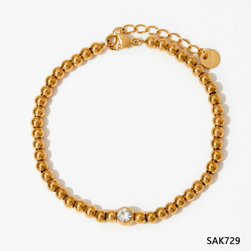 Stainless steel stacked bracelet with PVD-plated small gold beads and gold chain