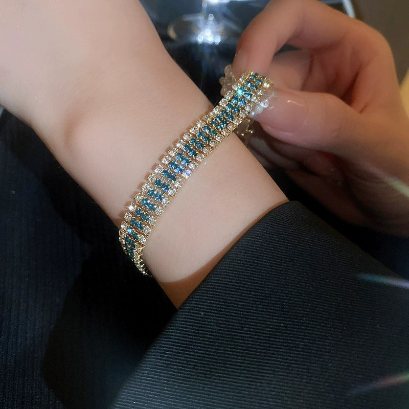 Retro-style, subtly luxurious stainless steel bracelet with diamond-encrusted geometric clasp.
